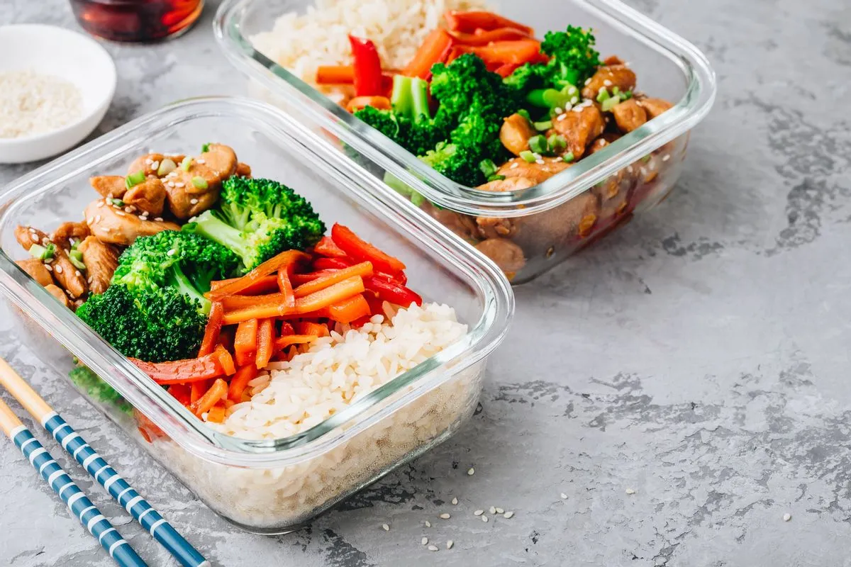 Open pan with raw vegetables and grains arranged loosely